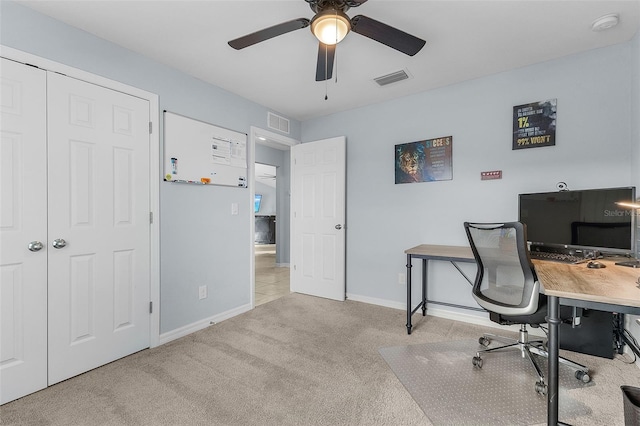 home office featuring ceiling fan and light carpet