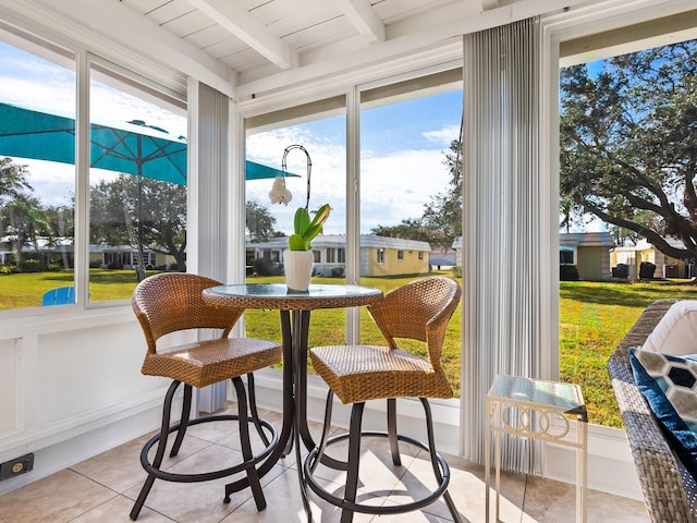 sunroom featuring beam ceiling