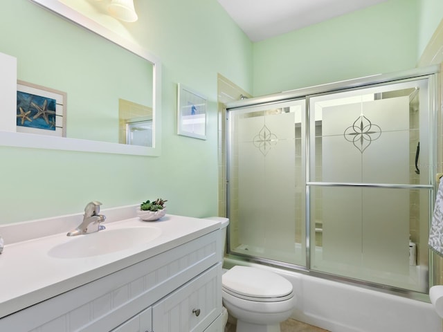 full bathroom with vanity, toilet, and enclosed tub / shower combo