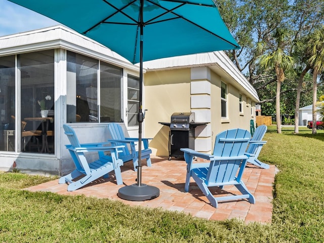 view of patio / terrace with area for grilling and a sunroom