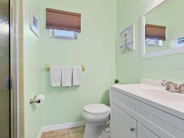 bathroom with a wealth of natural light, tile patterned flooring, vanity, and toilet