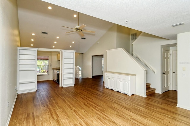 unfurnished living room with ceiling fan, light hardwood / wood-style flooring, high vaulted ceiling, and a textured ceiling