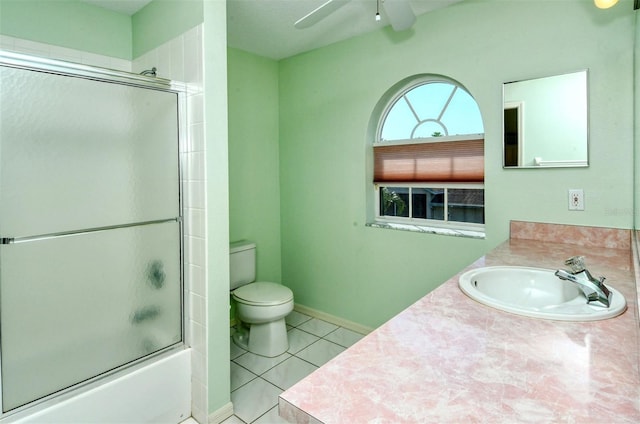 full bathroom featuring tile patterned flooring, vanity, toilet, and enclosed tub / shower combo