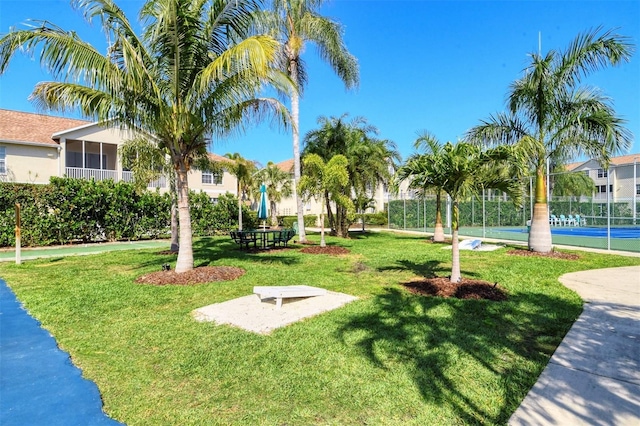 surrounding community featuring a lawn and tennis court