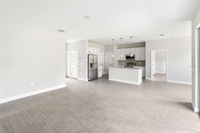 unfurnished living room featuring sink