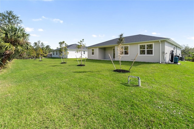 rear view of house featuring a lawn