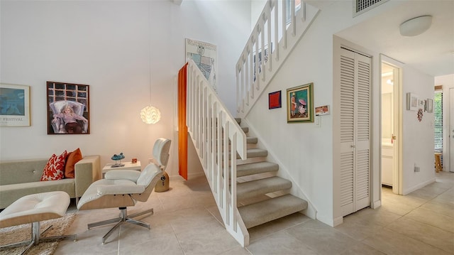 staircase featuring tile patterned floors