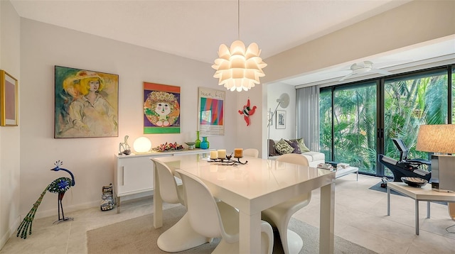 dining space featuring a notable chandelier and light tile patterned flooring