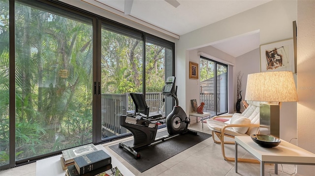 exercise room featuring light tile patterned floors and expansive windows