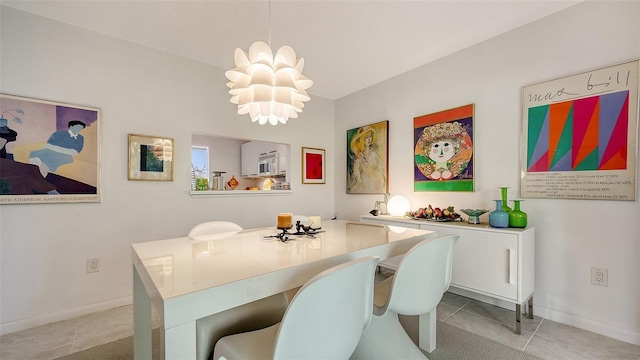 tiled dining space featuring an inviting chandelier