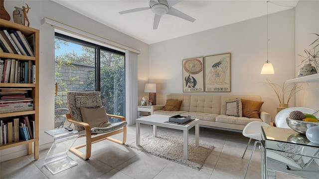 living area with ceiling fan and light tile patterned floors