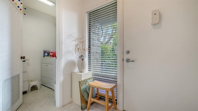 entryway with light tile patterned floors and washer / clothes dryer