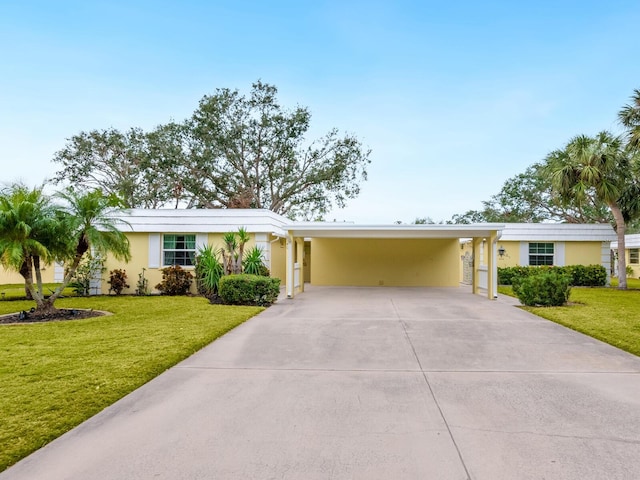 ranch-style house featuring a carport and a front yard