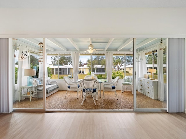 sunroom featuring ceiling fan and beamed ceiling