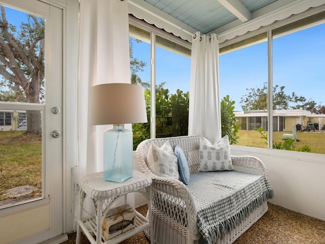 sunroom featuring beam ceiling