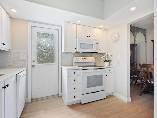 kitchen featuring white cabinets, decorative backsplash, white appliances, and light hardwood / wood-style floors