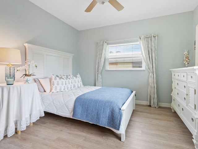 bedroom with light hardwood / wood-style floors and ceiling fan