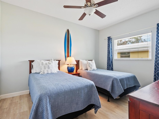 bedroom with ceiling fan and light wood-type flooring