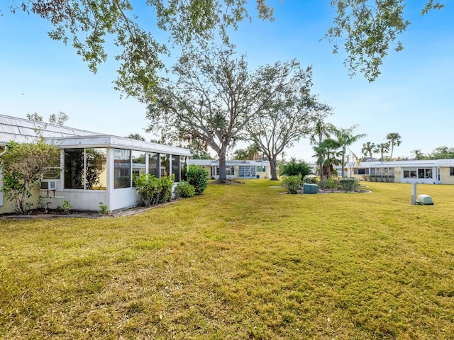 view of yard with a sunroom and cooling unit