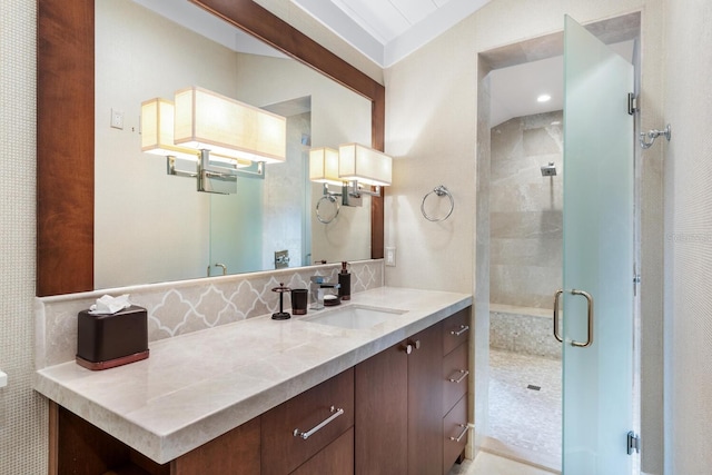 bathroom featuring walk in shower and vanity