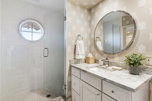 bathroom featuring an enclosed shower and vanity