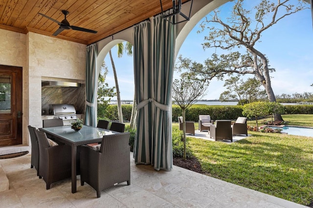 view of patio with ceiling fan and area for grilling