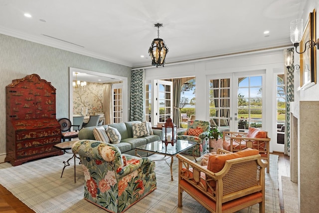 living room with wallpapered walls, recessed lighting, ornamental molding, and an inviting chandelier