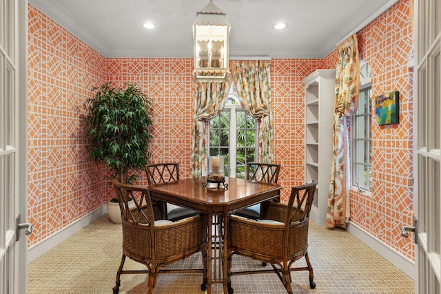 carpeted dining area featuring baseboards, ornamental molding, and recessed lighting