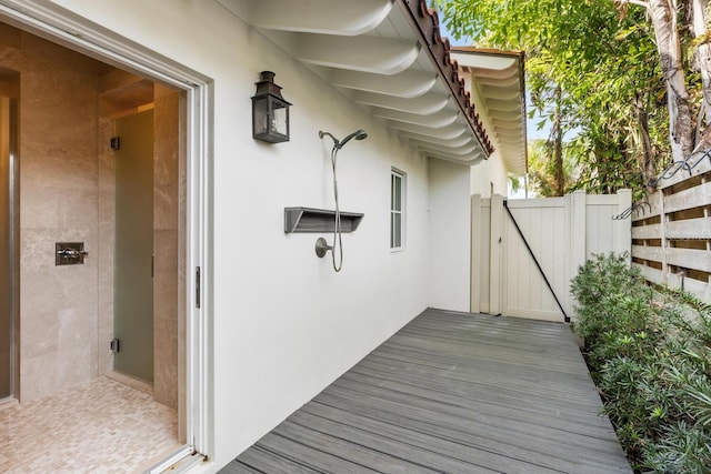 wooden deck featuring a gate and fence