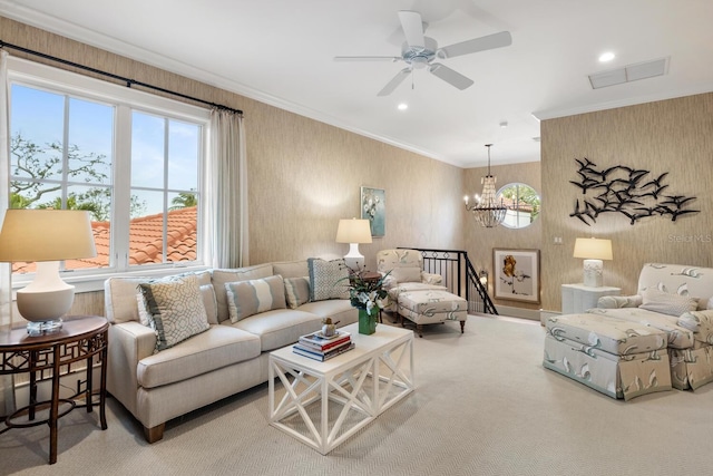 carpeted living room featuring ornamental molding, visible vents, recessed lighting, and ceiling fan with notable chandelier