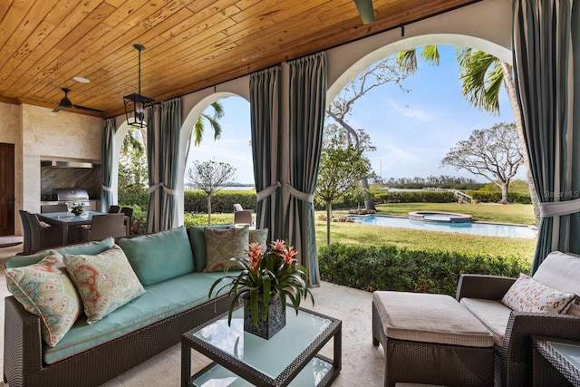 view of patio with grilling area, an in ground hot tub, an outdoor living space, and a ceiling fan