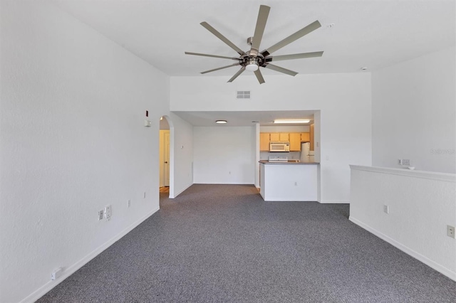 unfurnished living room featuring ceiling fan and dark carpet