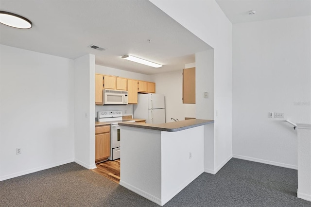 kitchen featuring kitchen peninsula, light brown cabinets, white appliances, and carpet floors