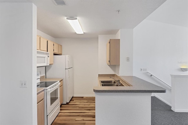 kitchen featuring light brown cabinetry, white appliances, a textured ceiling, sink, and hardwood / wood-style flooring