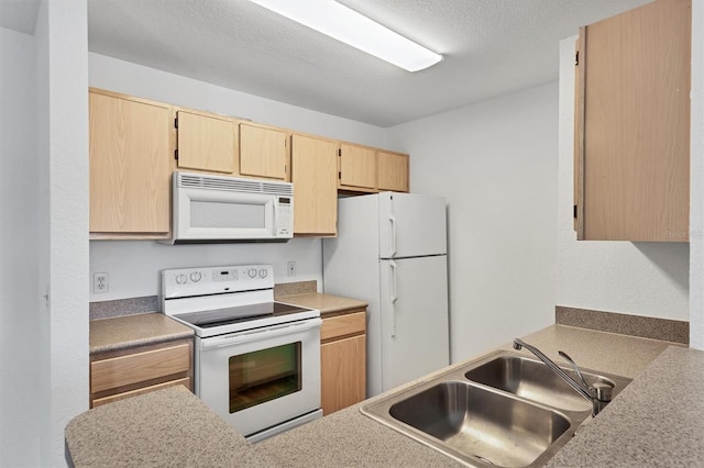 kitchen featuring light brown cabinets, white appliances, a textured ceiling, and sink