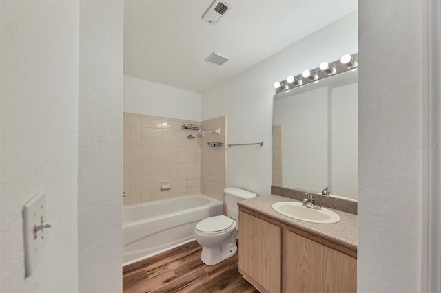 full bathroom featuring wood-type flooring, vanity, toilet, and tiled shower / bath