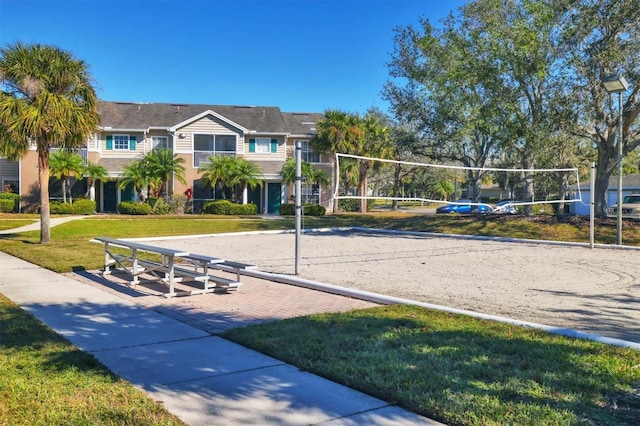 view of community with volleyball court and a yard