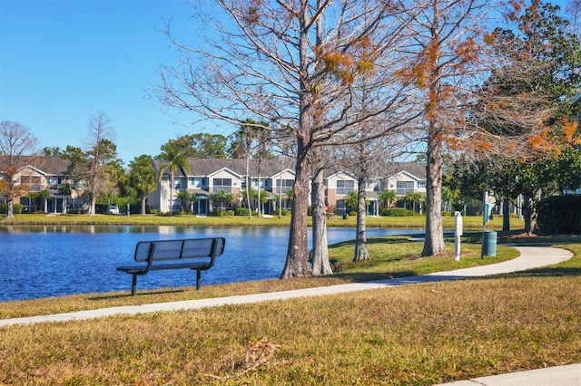 view of property's community featuring a water view and a yard