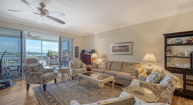 living room with ceiling fan, wood-type flooring, and ornamental molding