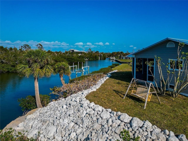 view of yard featuring a dock and a water view