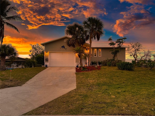 view of front of house with a yard and a garage