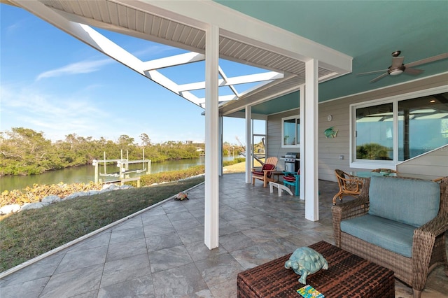 view of patio featuring a water view, area for grilling, and ceiling fan