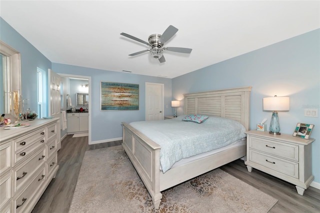 bedroom featuring ceiling fan, light wood-type flooring, and ensuite bath