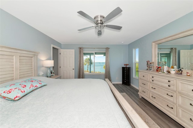 bedroom with ceiling fan and dark hardwood / wood-style floors