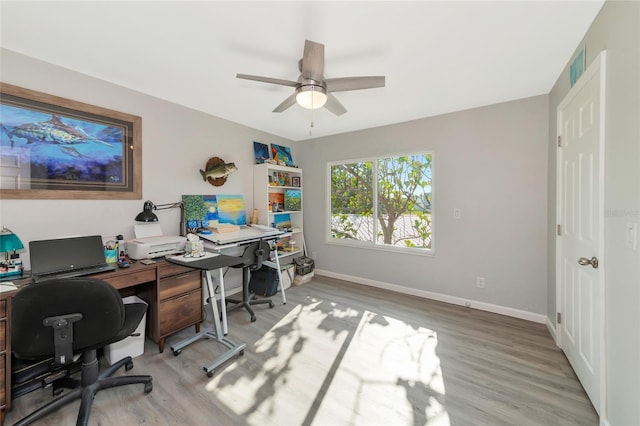 office with hardwood / wood-style flooring and ceiling fan