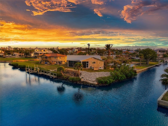 aerial view at dusk with a water view