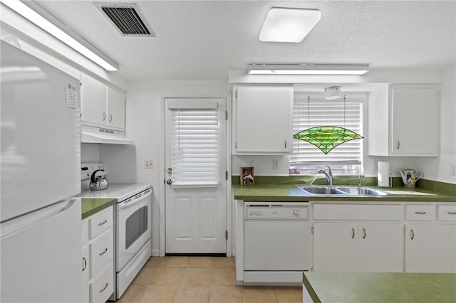 kitchen with sink, white cabinets, white appliances, and light tile patterned floors