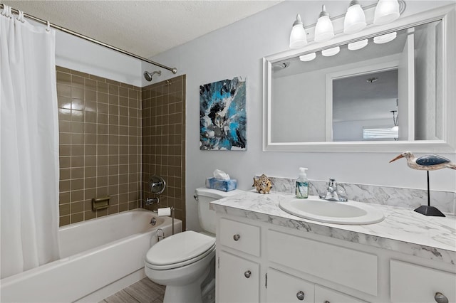 full bathroom with vanity, toilet, shower / bathtub combination with curtain, and a textured ceiling