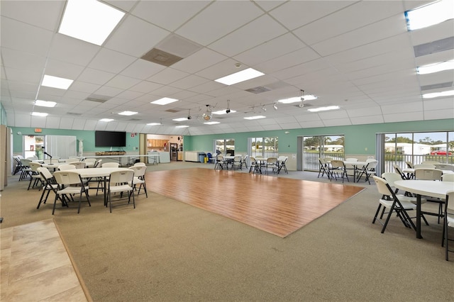 dining room featuring a drop ceiling