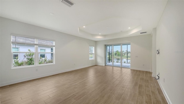 12649 Palatka Dr, Venice, FL 34293 - spare room with light hardwood / wood-style flooring and a tray ceiling